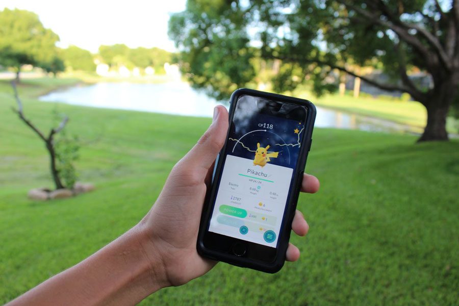 Students play the extremely popular game, Pokemon Go on campus.