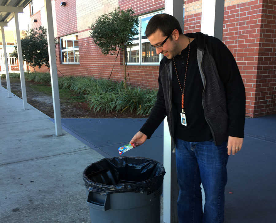 Mr. Stump teaches students the value of a clean campus by picking up litter.