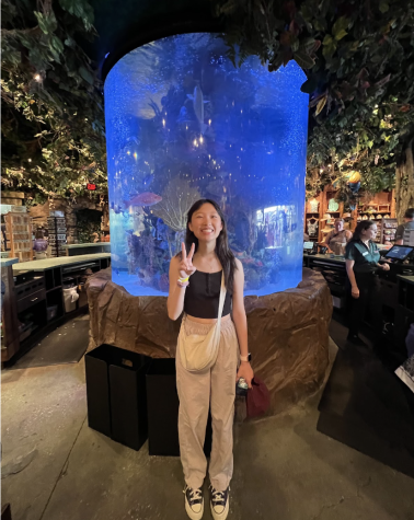 Reporter Chloe Park is posing in Disney Springs’s Rainforest Café.