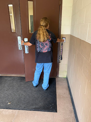 Maddison Bouthillier (sophomore) using her ID to get into the Health Academy building for class. 