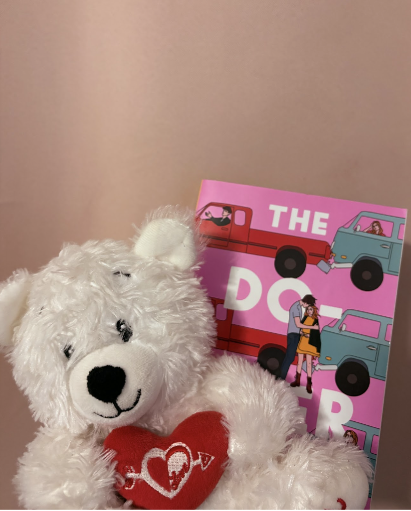 A Valentine’s Day teddy bear and The Do-Over, by Lynn Painter (a book that takes place on Valentine’s Day), against a pink background.