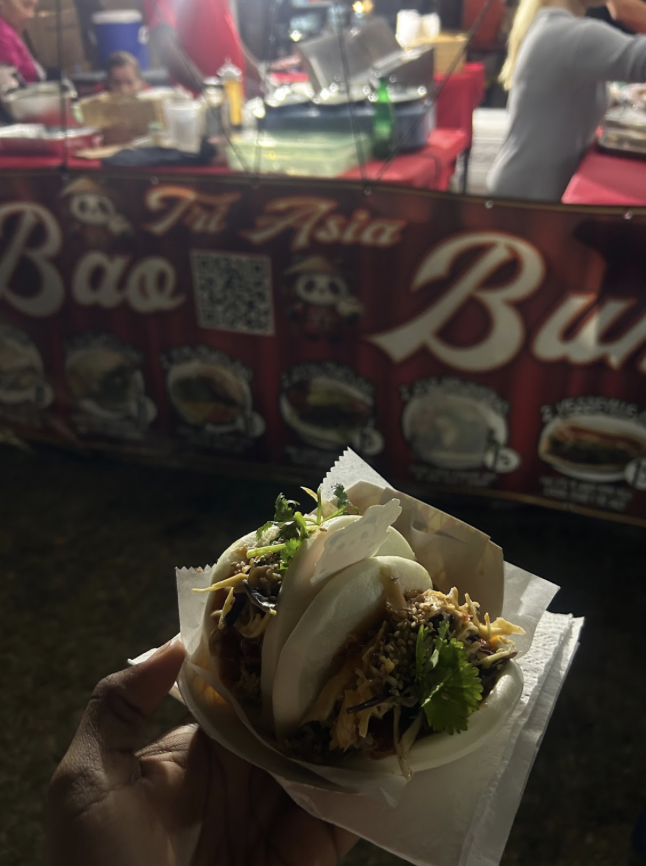 Two Bao buns with pulled chicken. 
